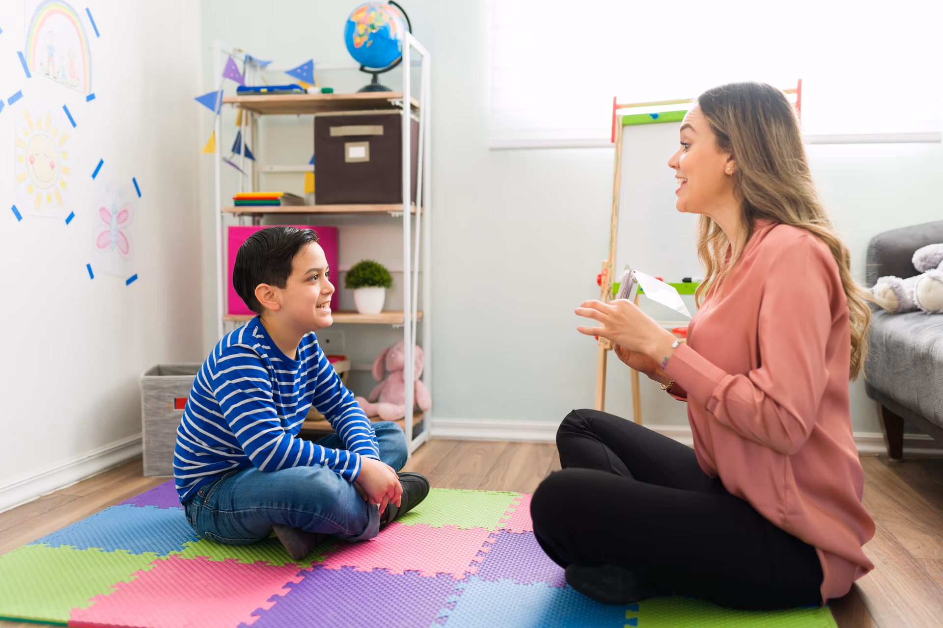 side view of a caucasian boy making sounds during speech therapy